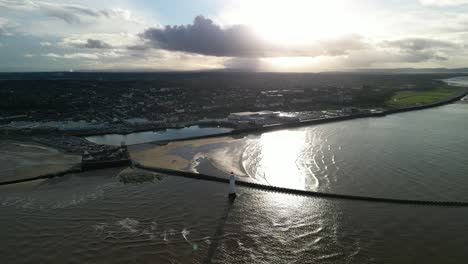 New-Brighton-Perch-Rock-Lighthouse,-River-Mersey,-Wirral---aerial-drone-high-clockwise-pan,-river-mouth-reveal-on-a-sunny-winter-afternoon-08