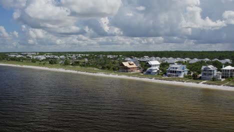 Aerial-shot-of-beach-front-homes-being-built-and-finished-close-to-natural-dunes-of-Cape-San-Blas-beach