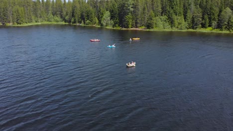 people kayaking in a mountain lake