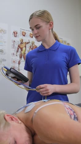 medical professional administering electrotherapy treatment