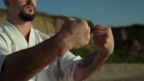 judo man warming up hands on nature close up. fighter doing arm exercises.