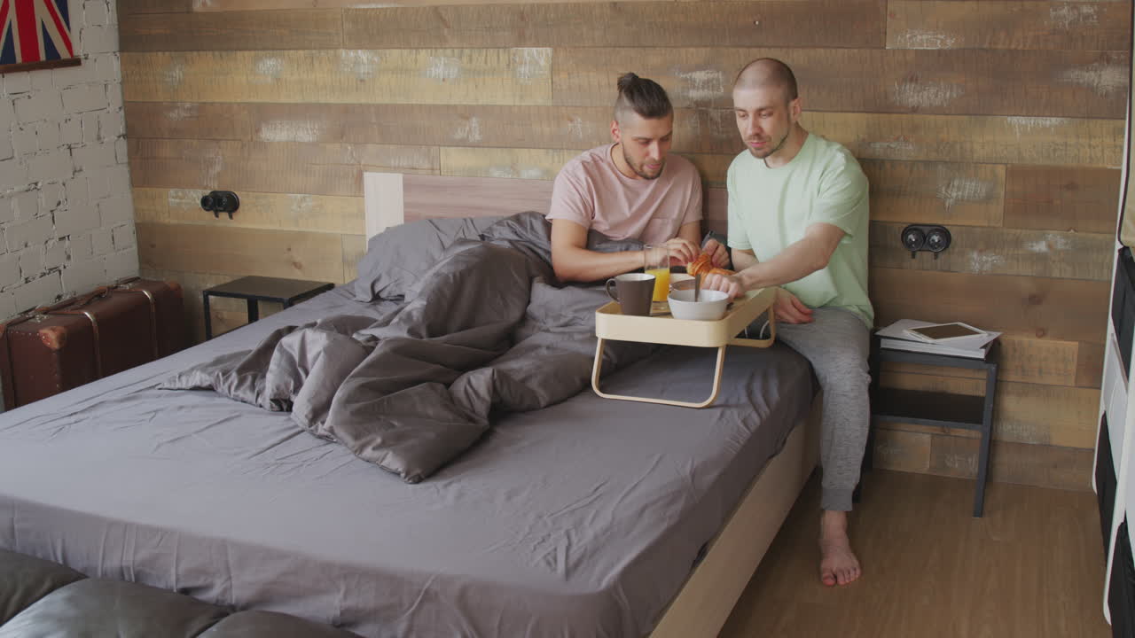 Loving Male Partners Enjoying Breakfast in Bed