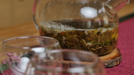 glass teapot with green tea and jasmine