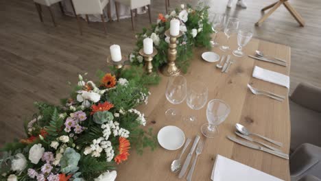 sweetheart table adorned with vibrant floral arrangements and elegant candle settings