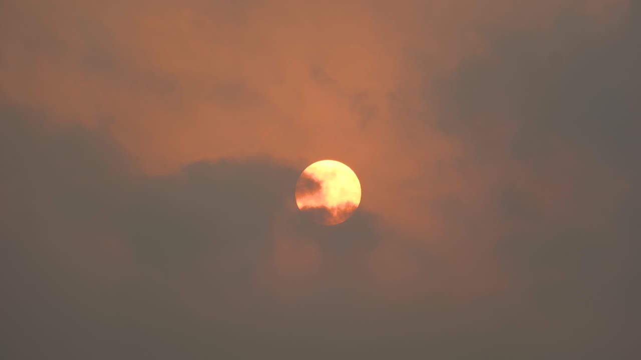 Ablaze in the Sky: Witnessing the Fiery Red Sun and Floating Clouds in Bangladesh