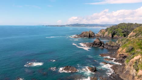 aerial drone flying over an ocean at a beautiful rocky shore