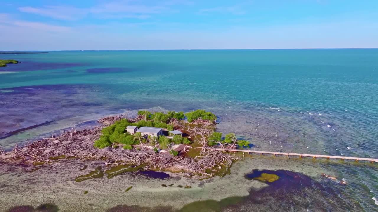 Aerial view of a small island with a house and dock