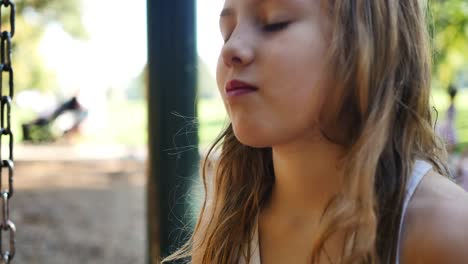 Close-up-of-blonde-girl-as-she-listens-to-playground-conversation