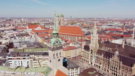 st. peter's church tower and the old town hall in marienplatz, munich, germany. aerial drone shot