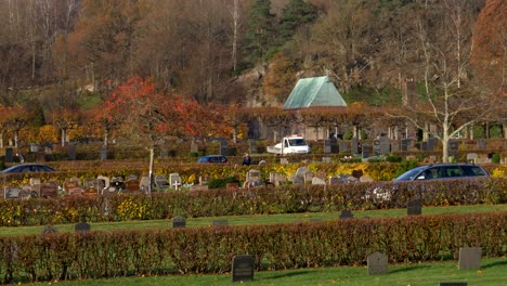 coches circulando en el cementerio de kviberg en gotemburgo, suecia durante la temporada de otoño
