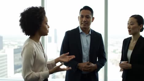 a dynamic business discussion among professionals in a modern office setting, highlighting team collaboration and engaging conversations with a scenic city view