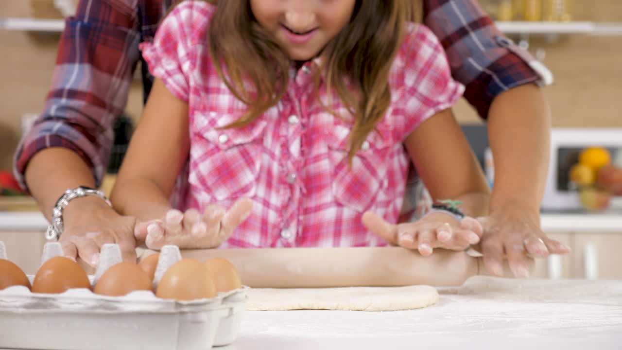 Mother and daughter baking together in the kitchen