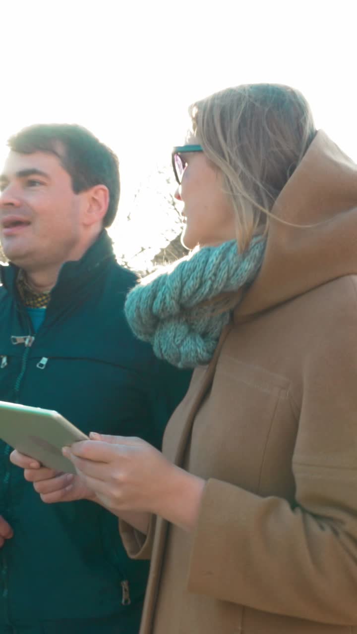 People Using Tablet Outdoors