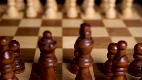 sliding over wooden brown chess figures