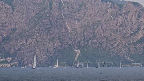 sailing yachts racing in regatta water sport event with mountain view