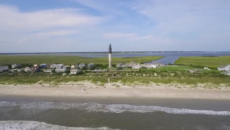 drone flying towards lighthouse over the ocean