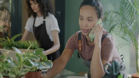 woman florist talking on phone and taking notes