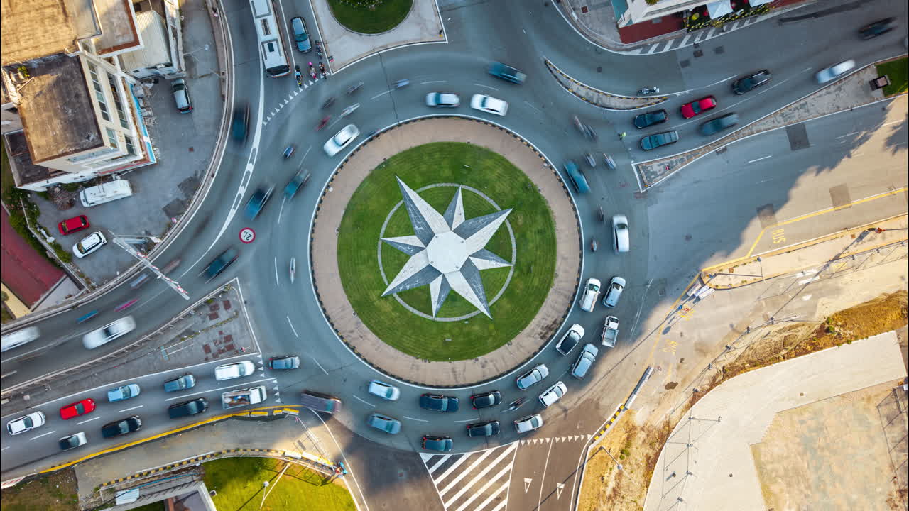 Aerial hyperlapse of cars moving fast around roundabout in Genoa, Italy, urban city traffic from top view