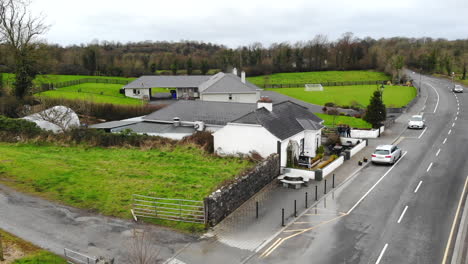 Aerial---Main-road-of-a-downtown-nearby-the-river-and-the-cafe-on-the-roadside