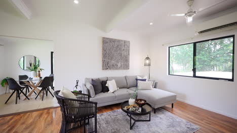 Luxurious Modern Wooden Floors Interior Design Loungeroom and Light Grey Sectional Couch with Black Accent Chairs