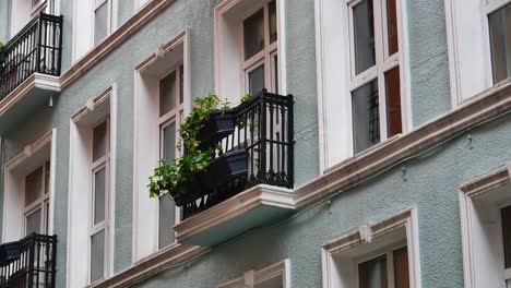 exterior of a multi-story building with balconies and flowers