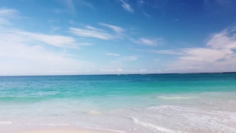 Gentle-waves-lapping-Eden-Beach-with-rocks-of-Alkimos-Reef-in-background