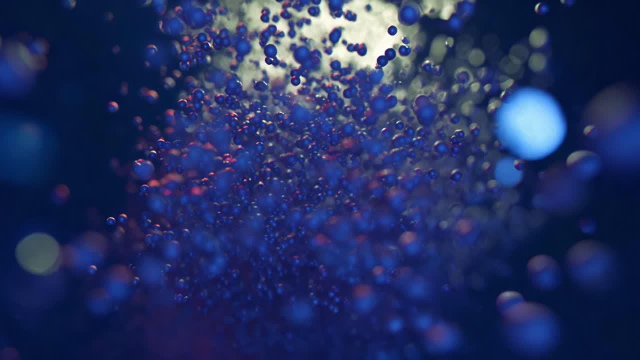Colorful blue, red and iridescent glitter particles rise and burst in a dark fluid, creating chaotic molecular reactions, bokeh highlights and flowing, otherworldly underwater motion effects