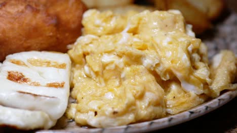 breakfast plate with scrambled eggs, feta, and fries