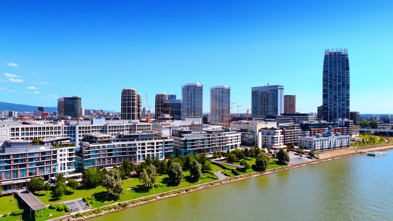 Bratislava, Slovakia - June 14, 2025: Bratislava river skyline. Bratislava features a vibrant skyline with modern architecture by the serene river, showcasing urban beauty