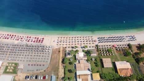 fabulous beautiful magic landscape with umbrellas and sun beds on the seafront on antisamos beach on a sunny day on the coast of the ionian sea in kefalonia, greece