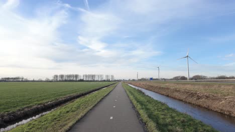 scenic countryside landscape with bicycle path in the netherlands - drone shot