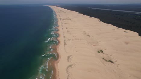 long stretch of white sand at stockton beach in new south wales, australia - aerial drone shot