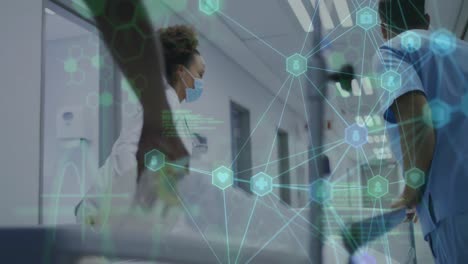 animation of network of connections with icons over doctors in face masks in hospital