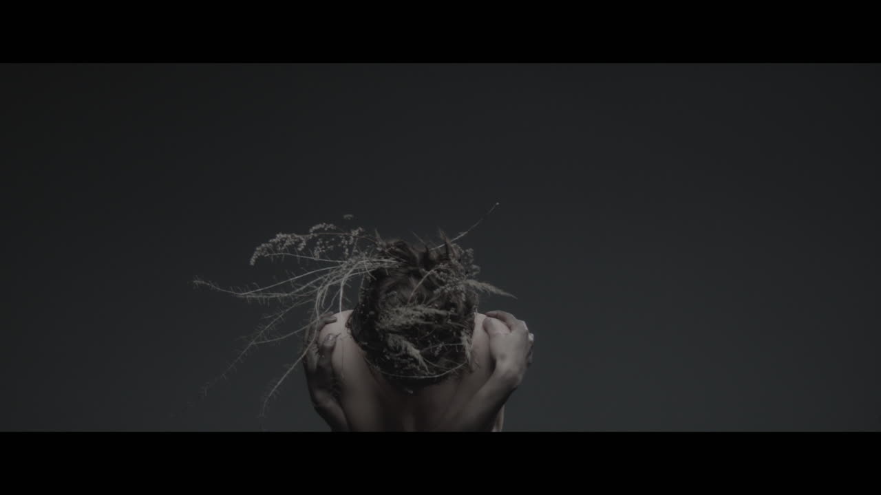 A woman dressed as mother nature rise her head