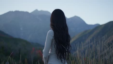 young beautiful woman looks at nature and mountain views