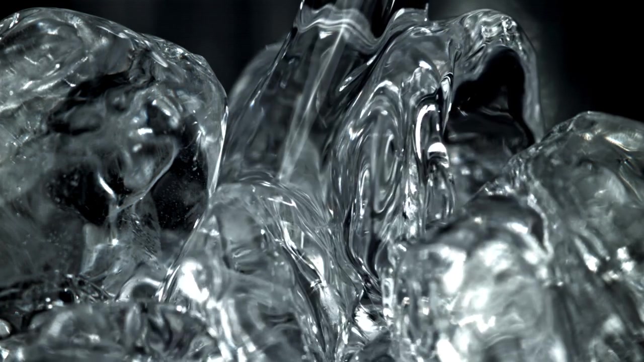 Close-up of Water Flowing Over Glistening Ice Cubes in Slow Motion