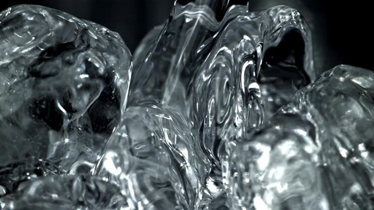 Close-up of Water Flowing Over Glistening Ice Cubes in Slow Motion