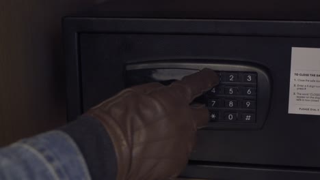 a burglar trying to open a safe and fails