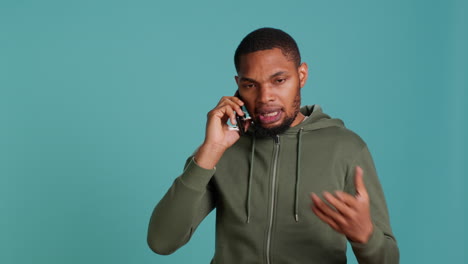 Irked-man-fighting-with-friends-during-telephone-call