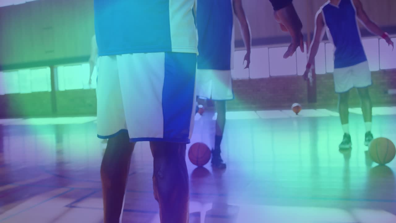 Male player holding stretch releasing and stepping as basketball drill starting and balls rolling