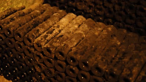 rows of dusty wine bottles in a cellar