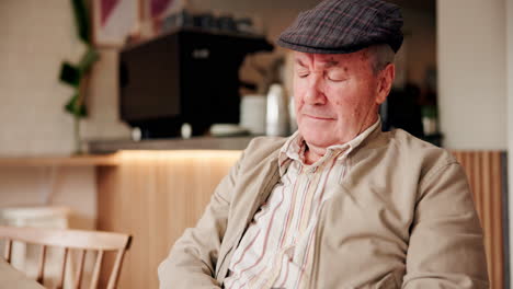 elderly man resting in a coffee shop