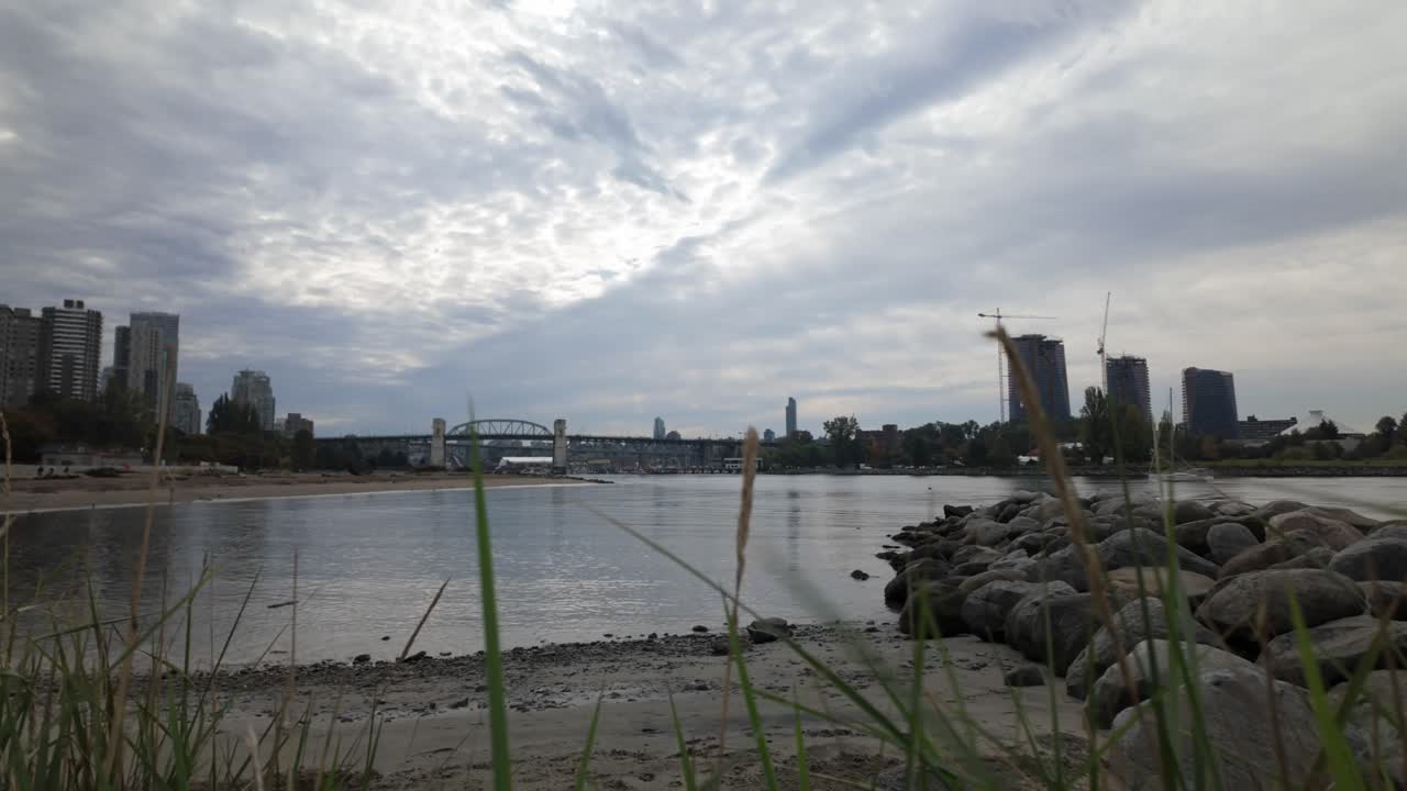 Gimbal wide panning shot of English Bay Beach on a cloudy day in Vancouver, British Columbia, Canada. 4K at 30 FPS