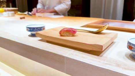 chef prepares sushi at a japanese restaurant