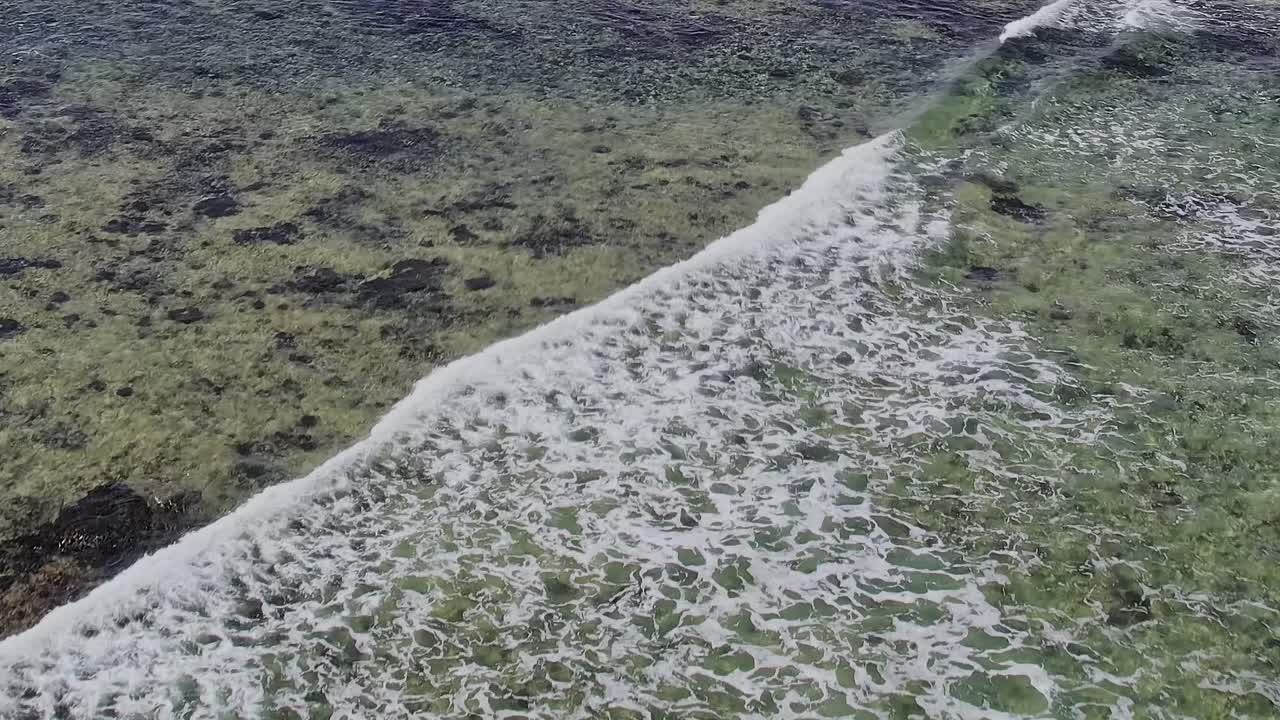 Ocean waves crash on the shore in Canary Islands, Spain during the day