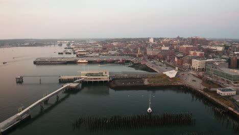 Aerial-shot-sliding-above-Portland-harbor-at-dawn,-Maine