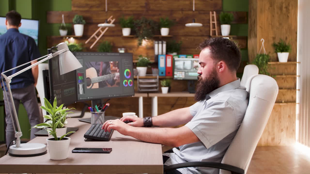 Man editing video at his workstation