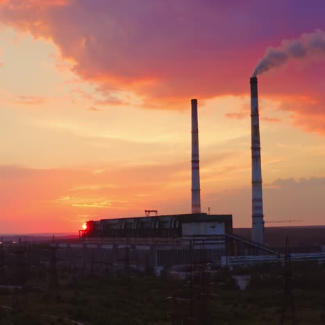 harmful industry causes ecological problems. dangerous smoke goes from chimney of manufacturing on the colorful sky background.