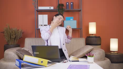 home office worker young woman yawns and relaxes at the camera.