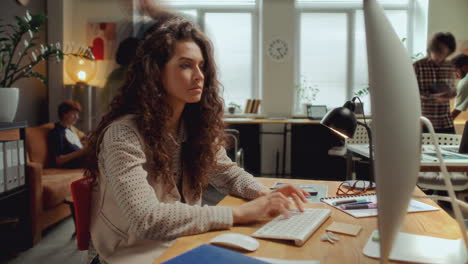 timelapse of young woman working on computer during day in office